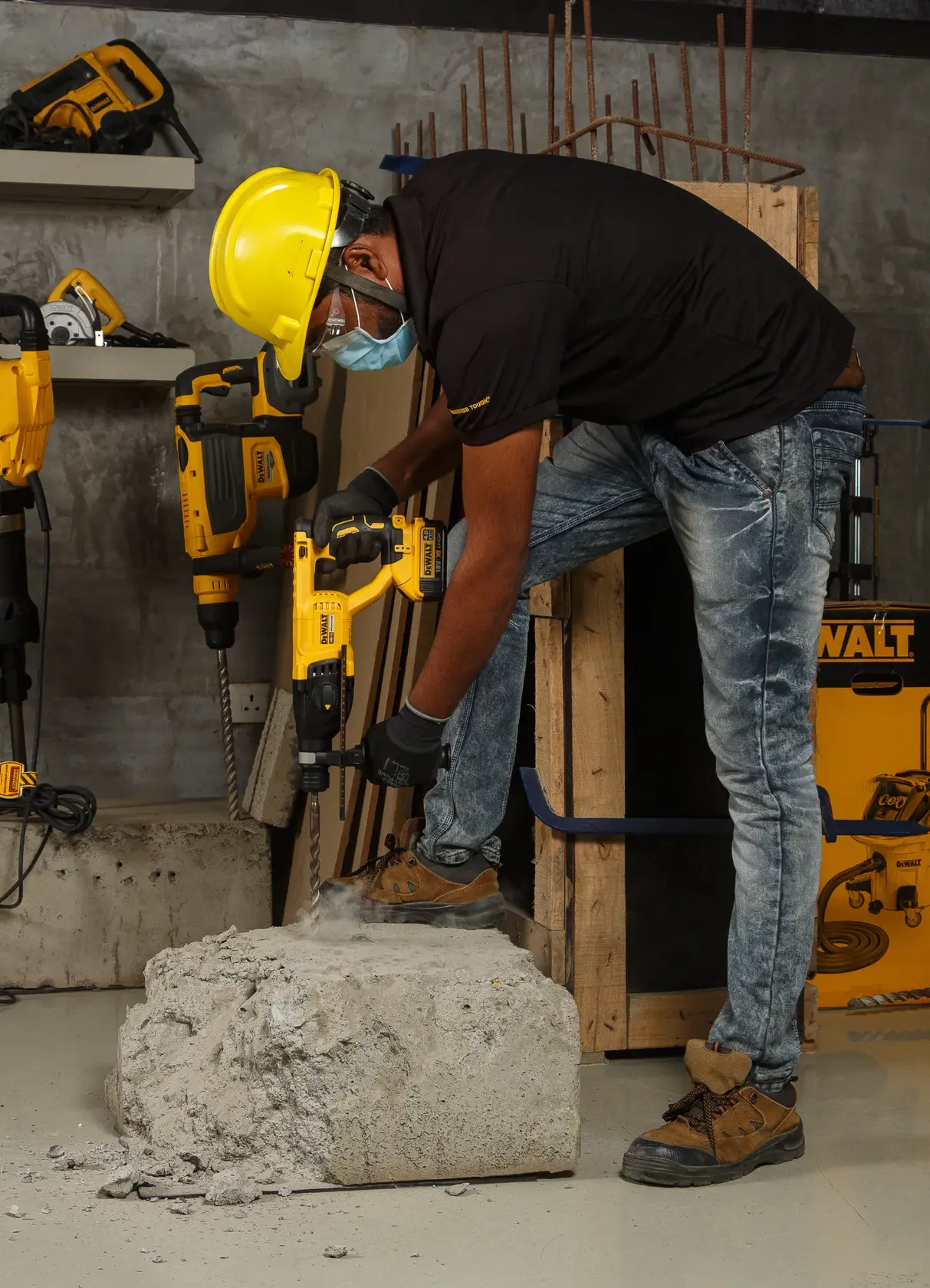 Photo of worker using DEWALT rotary hammer DCH133NT, DCH133NT-XJ, DCH133N-XJ drilling concrete in workshop.