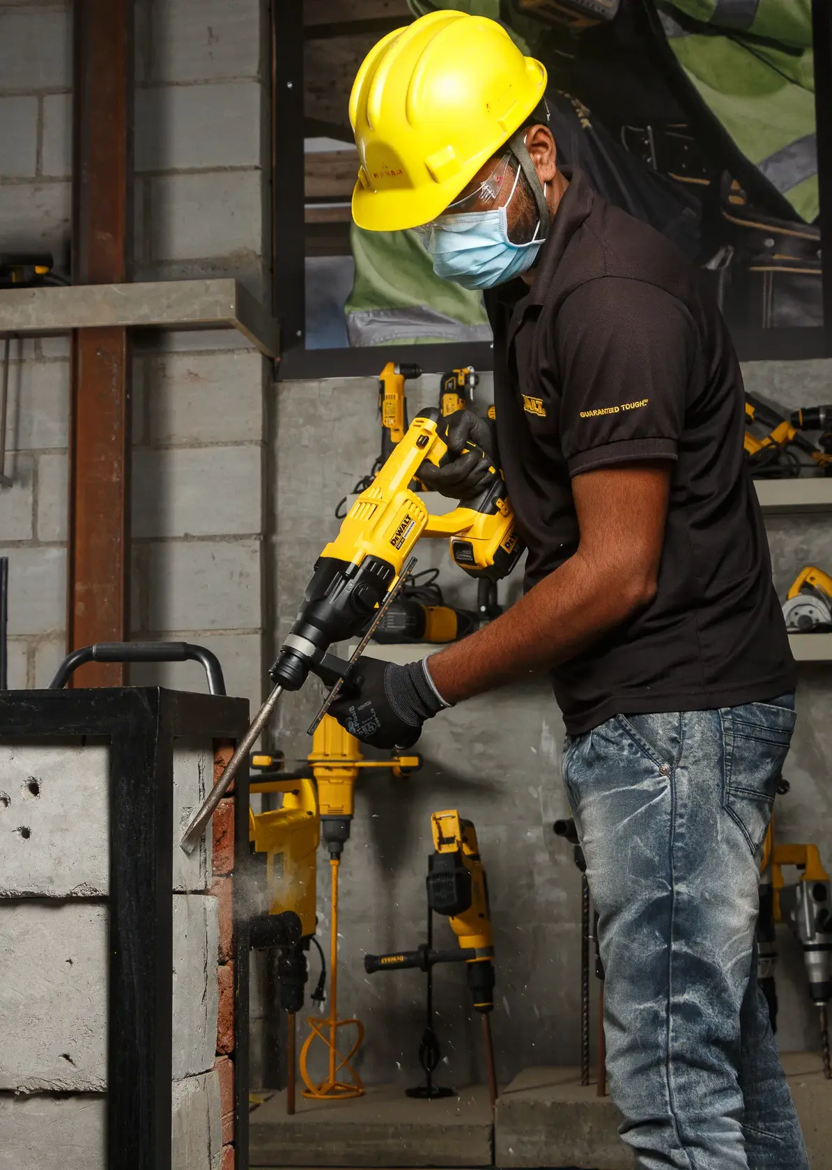 Photo of DEWALT rotary hammer DCH133NT, DCH133NT-XJ, DCH133N-XJ used by worker on concrete, indoor, side view.