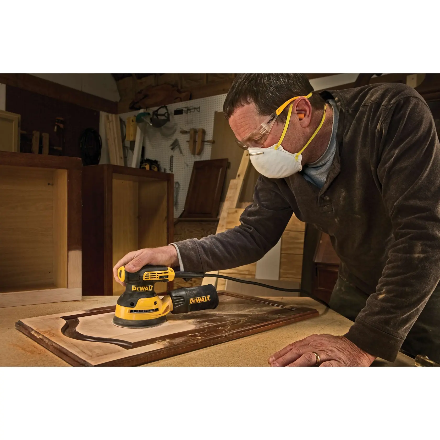 Close-up view of a DEWALT power tool with a black and yellow design, showing a 'PERFORM PROTECT' label in red and yellow on the tool and below it.